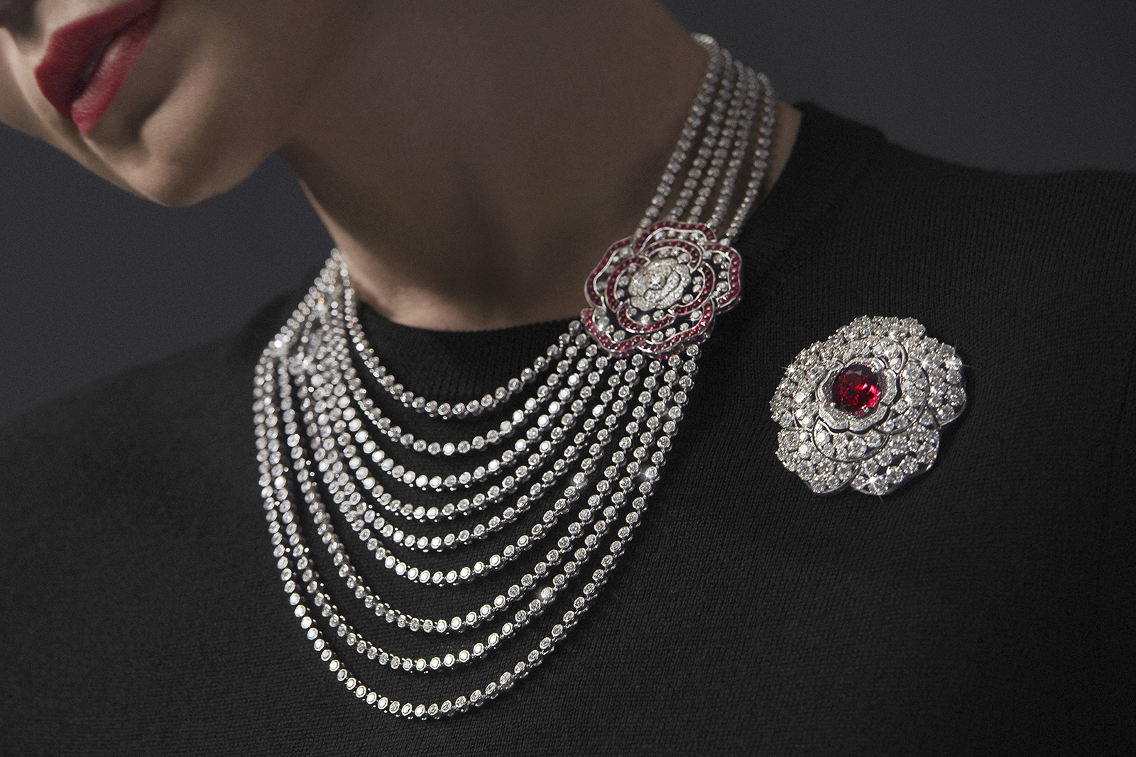 Chanel '1.5. 1 CAMÉLIA . 5 ALLURES' collection 'Rouge Incandescent' transformable necklace, in white gold, rubies and diamonds. Detachable camellia motif that may be worn as a brooch, and reveals another openwork camellia motif
