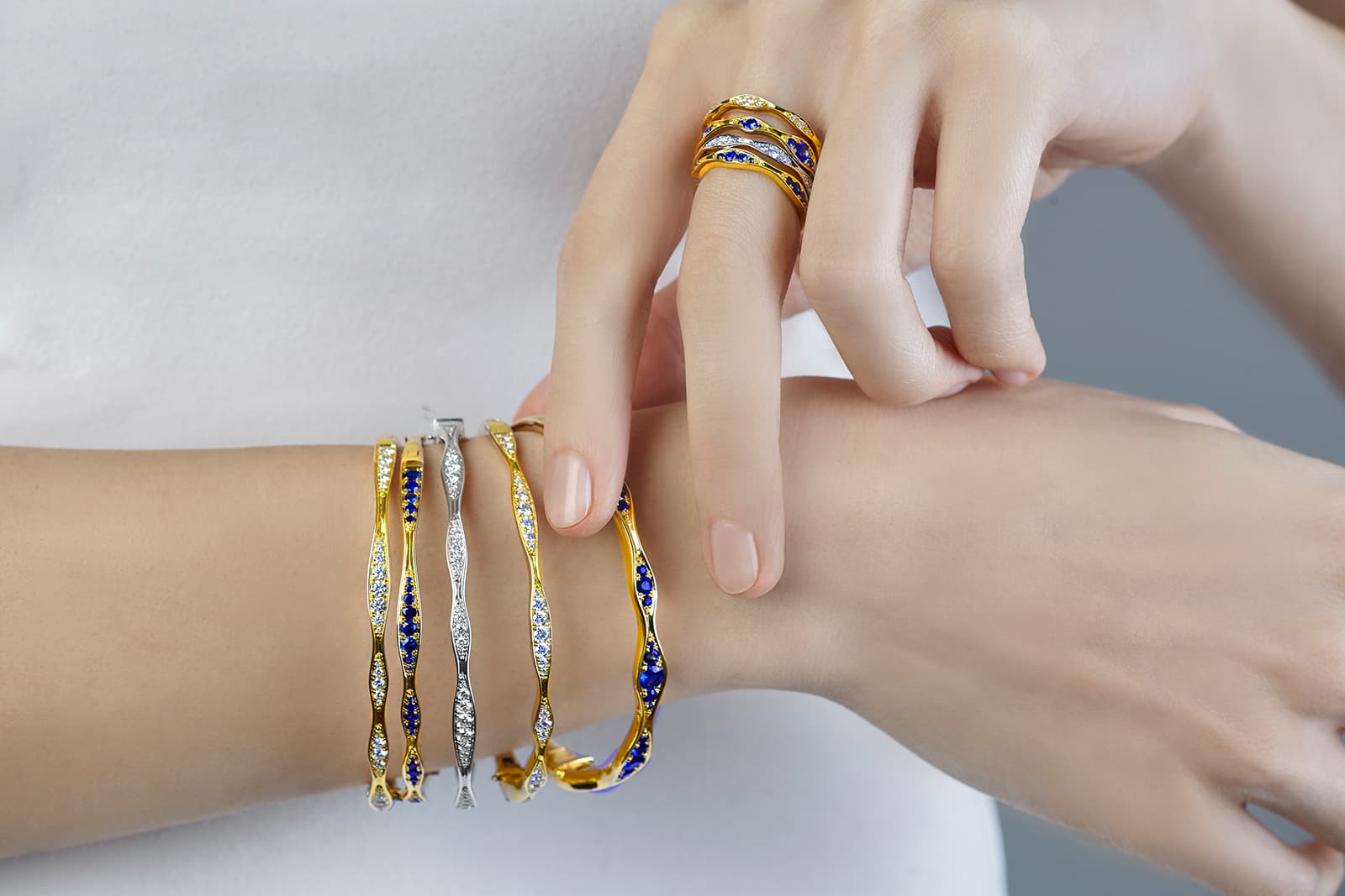 Maria Canale 'Wave' collection rings and bangles with sapphires and diamonds in 18k white or yellow gold respectively