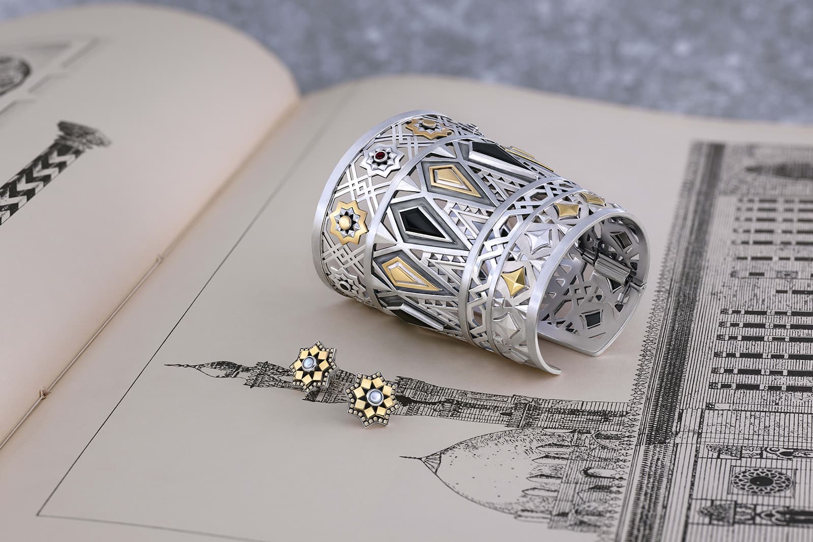 Azza Fahmy 'Mamluk' collection ‘Qalawun’ cuff with onyx and garnet and ‘Qalawun’ earrings with diamonds and pearls, both in yellow gold and sterling silver