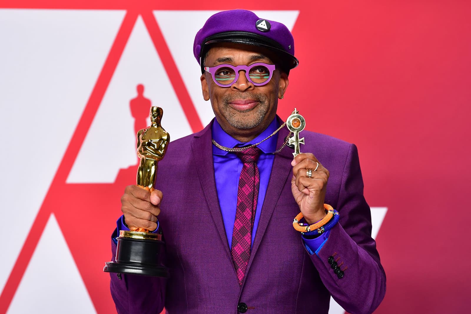 Spike Lee wearing Amedeo Scognamiglioa bespoke pendant with diamonds and fire opal in yellow gold