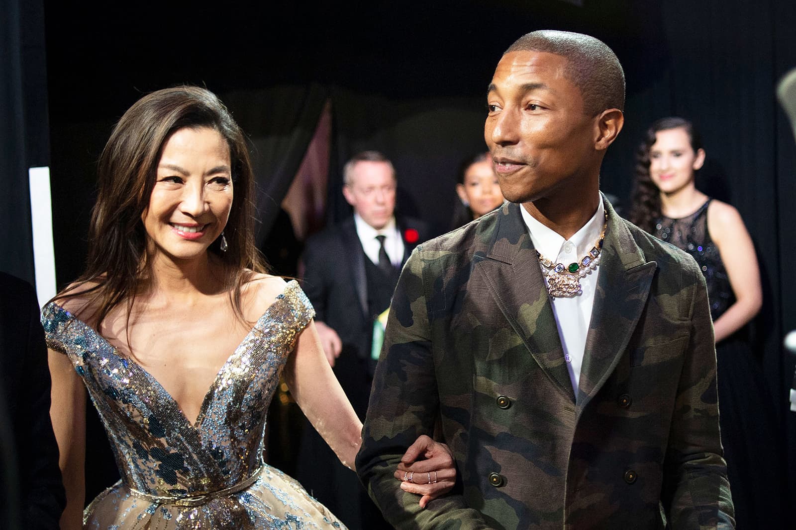 Pharrell Williams wearing Jacob & Co. necklace with diamonds, emeralds and sapphires in yellow gold, and bespoke Chanel necklace with pearls and diamonds in white gold