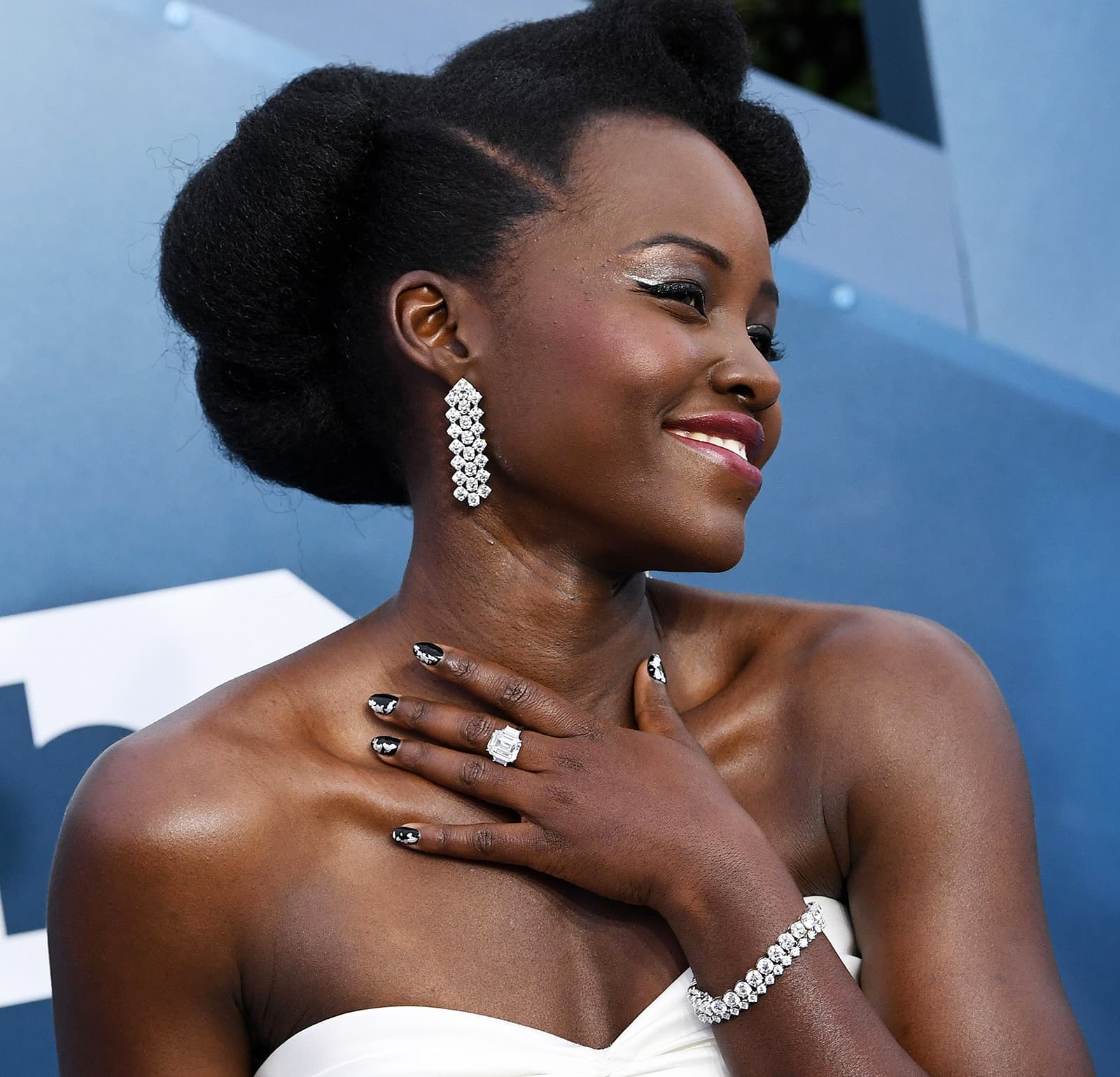 Lupita Nyong’o wearing Forevermark chandelier earrings, bracelet and ring with diamonds totaling 90ct