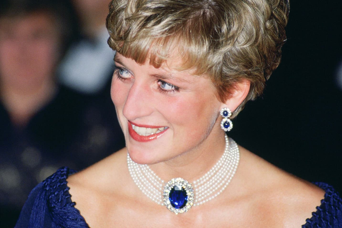 Princess Diana wearing her seven strand pearl choker with sapphire and diamond clap, and earrings with sapphires and diamonds