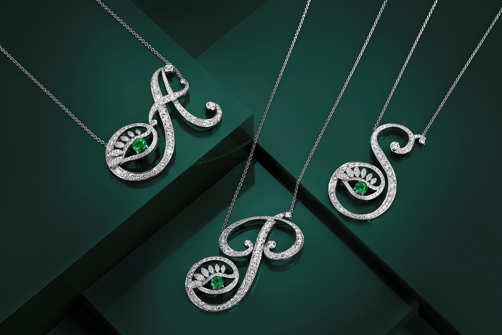 Tabayer alphabet pendants with emeralds and diamonds in white gold