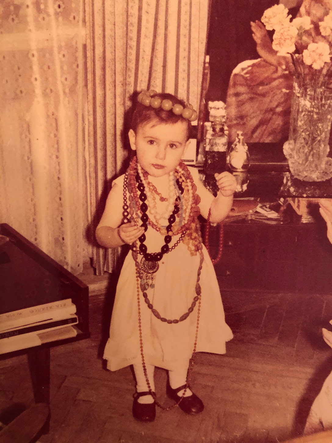 Katerina Perez at 2 years old wearing grandmother's jewellery