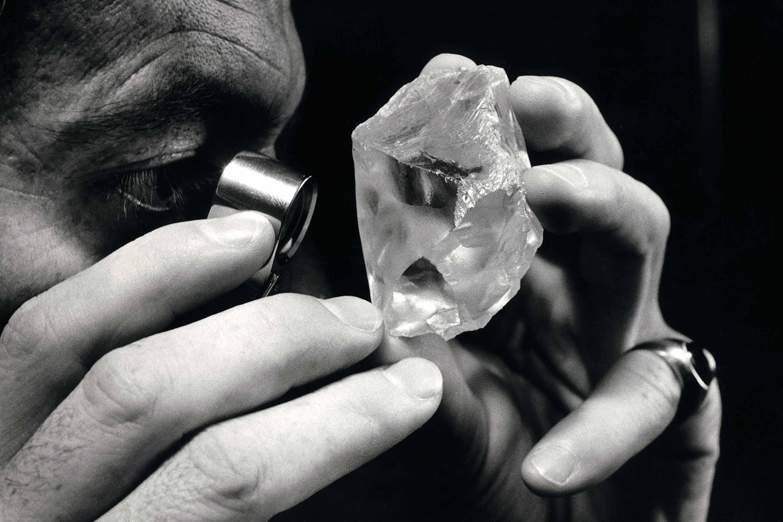 A gemmologist uses a loupe to examine the 603-carat Lesotho Promise rough diamond