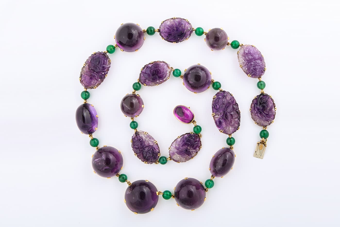 René Boivin 1950s cabochon and carved amethyst necklace and bracelet, interspersed with chrysoprase beads, in 18 carat gold. Sold by A La Vieille Russie