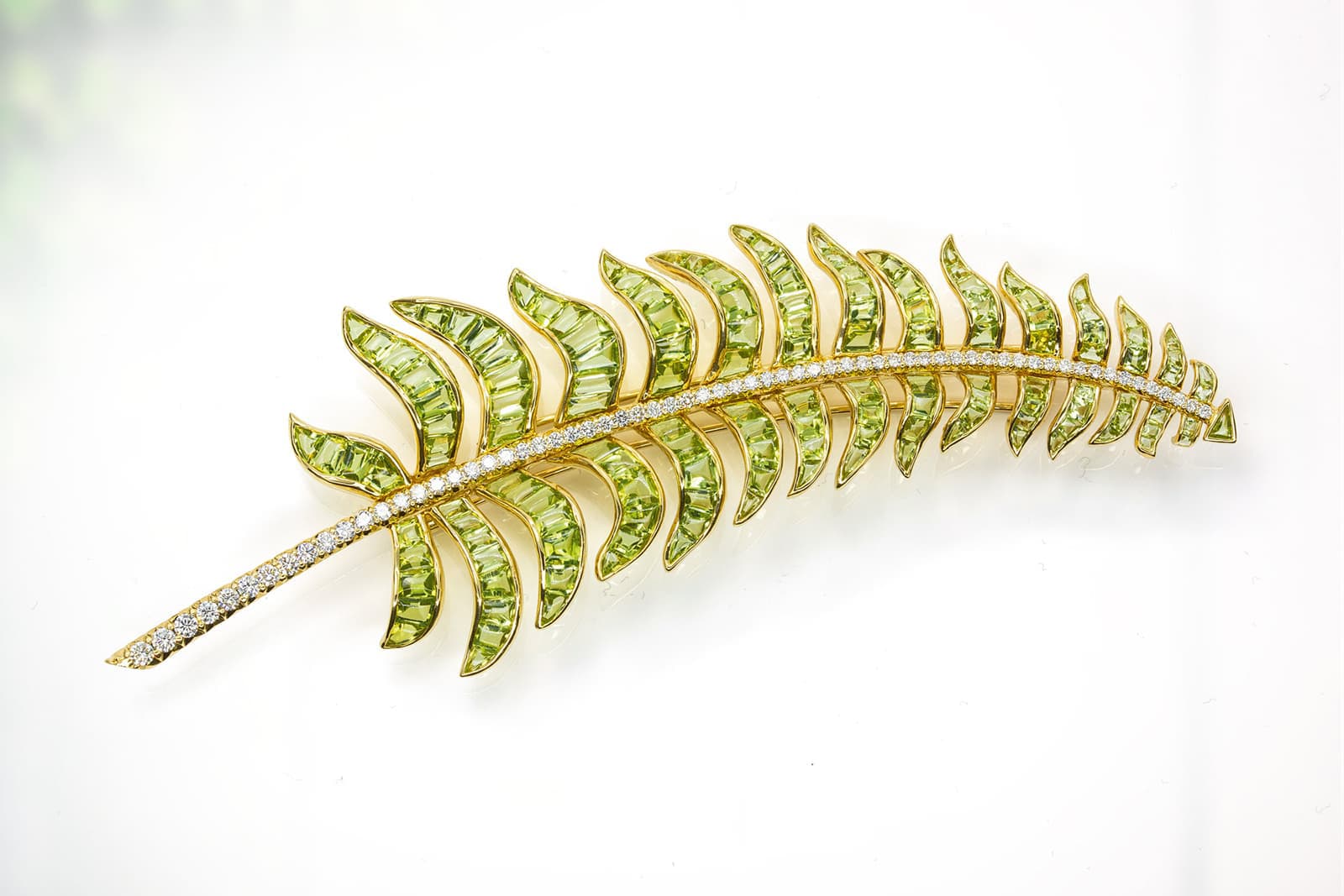 Michelle Dela Valle peridot and diamond feather brooch in yellow gold