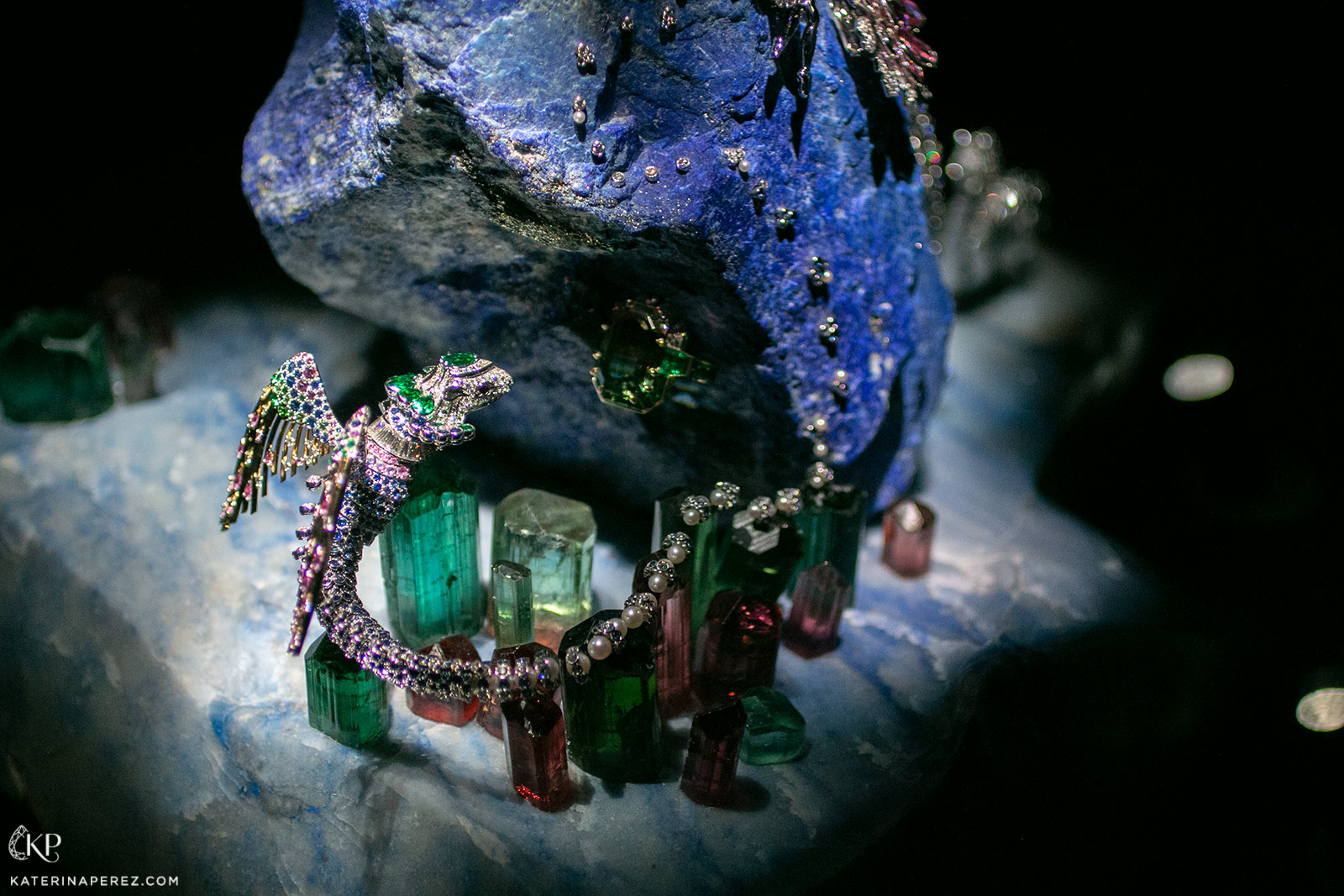 Perched on crystals of tourmaline, a gem-set chimera spreads its precious wings 
