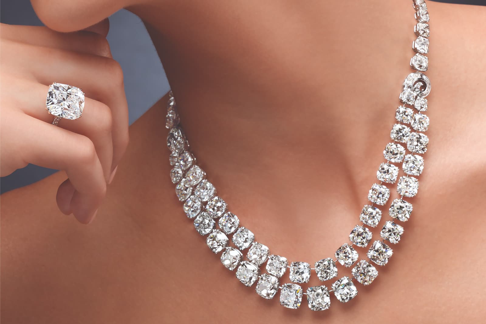 A double row 119.03 carat antique cushion-cut diamond necklace, a 14.28 carat cushion-cut diamond ring, and a pair of 10.20 carat cushion-cut diamond earrings by Ronald Abram