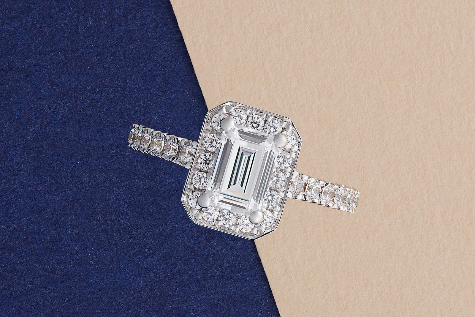 Taylor & Hart emerald-cut diamond engagement ring with a pavé diamond halo set in platinum