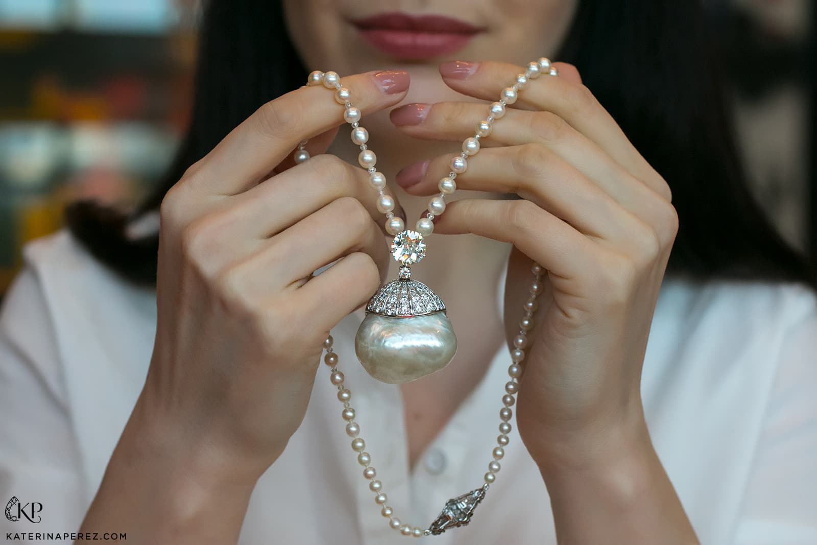 Katerina holds an incredible baroque pearl necklace with diamonds