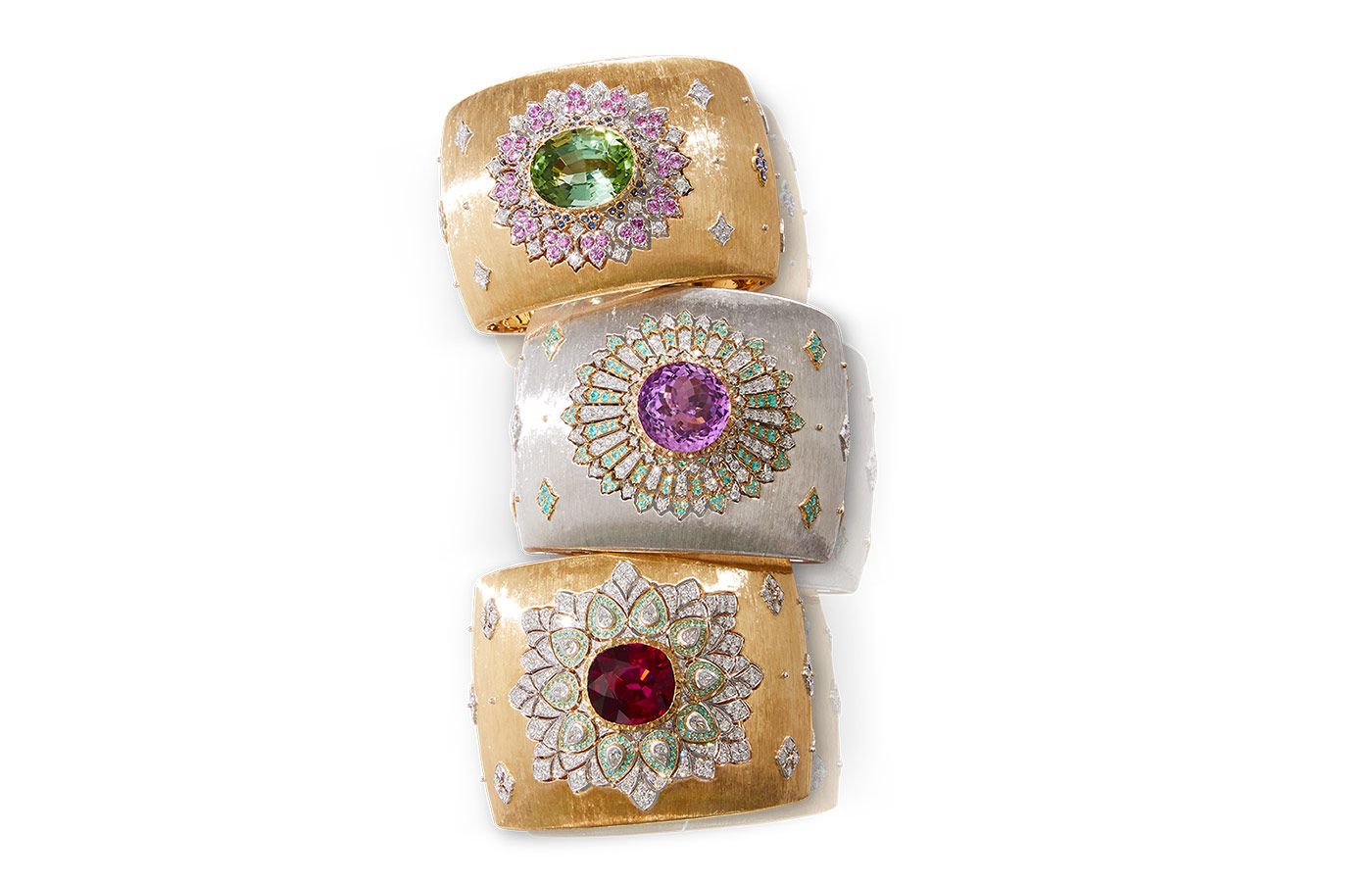 Cuff bracelets from the Il Giardino di Buccellati High Jewellery collection, including (from top to bottom) the Lilium cuff, the Aubreta cuff and the Dans du Feu cuff set with a large faceted tourmaline, kunzite and rubellite, respectively