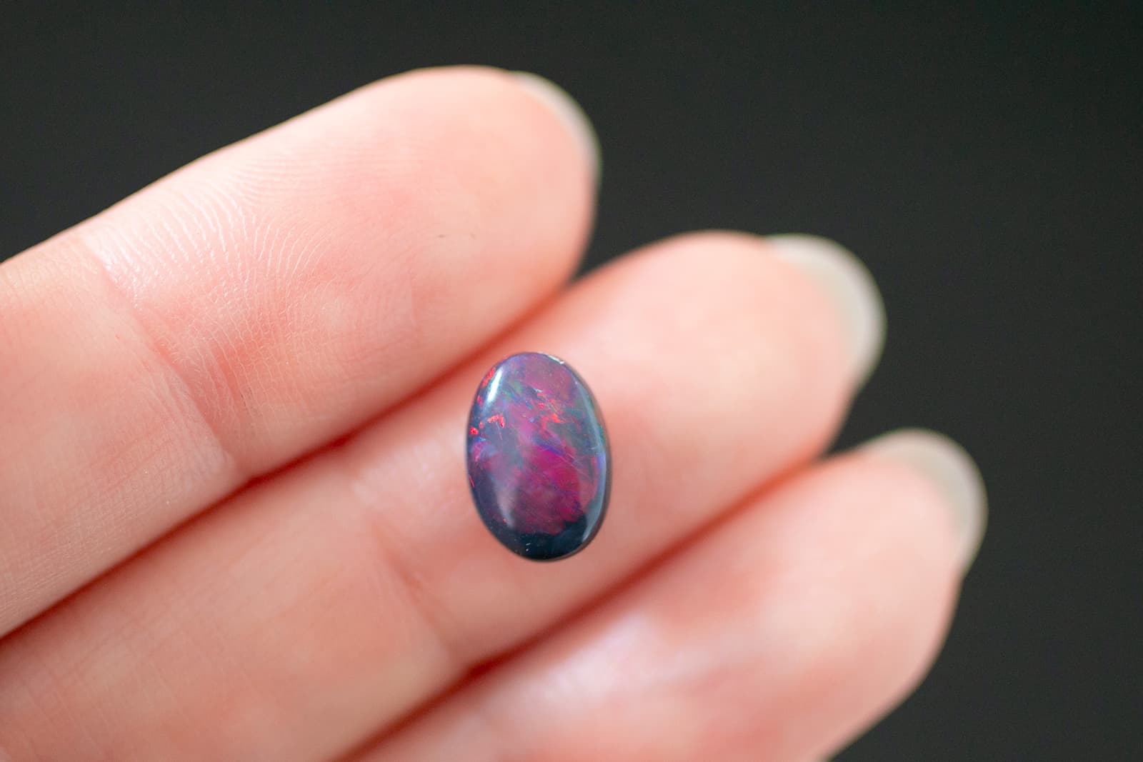 A small Australian black opal with an extraordinary red-purple play of colour, courtesy of IMAGEM