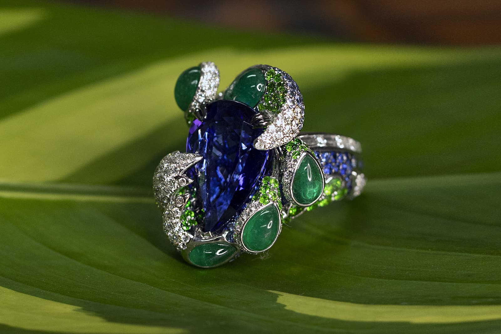 Alessio Boschi Journey to the Americas ring in rose gold, white gold, emerlads, tanzanite, sapphires, diamonds and demantoid garnets  