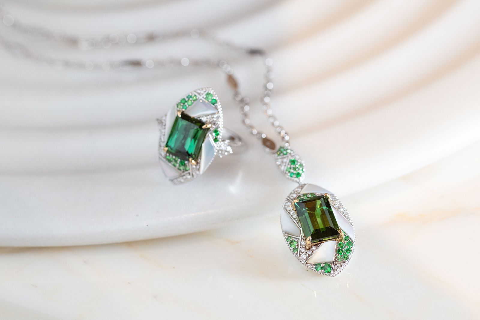 Sunita Nahata pendant and ring with green tourmalines, tsavorites, mother of pearl and diamonds in 18k white and yellow gold from the Mystic Green Tourmaline collection