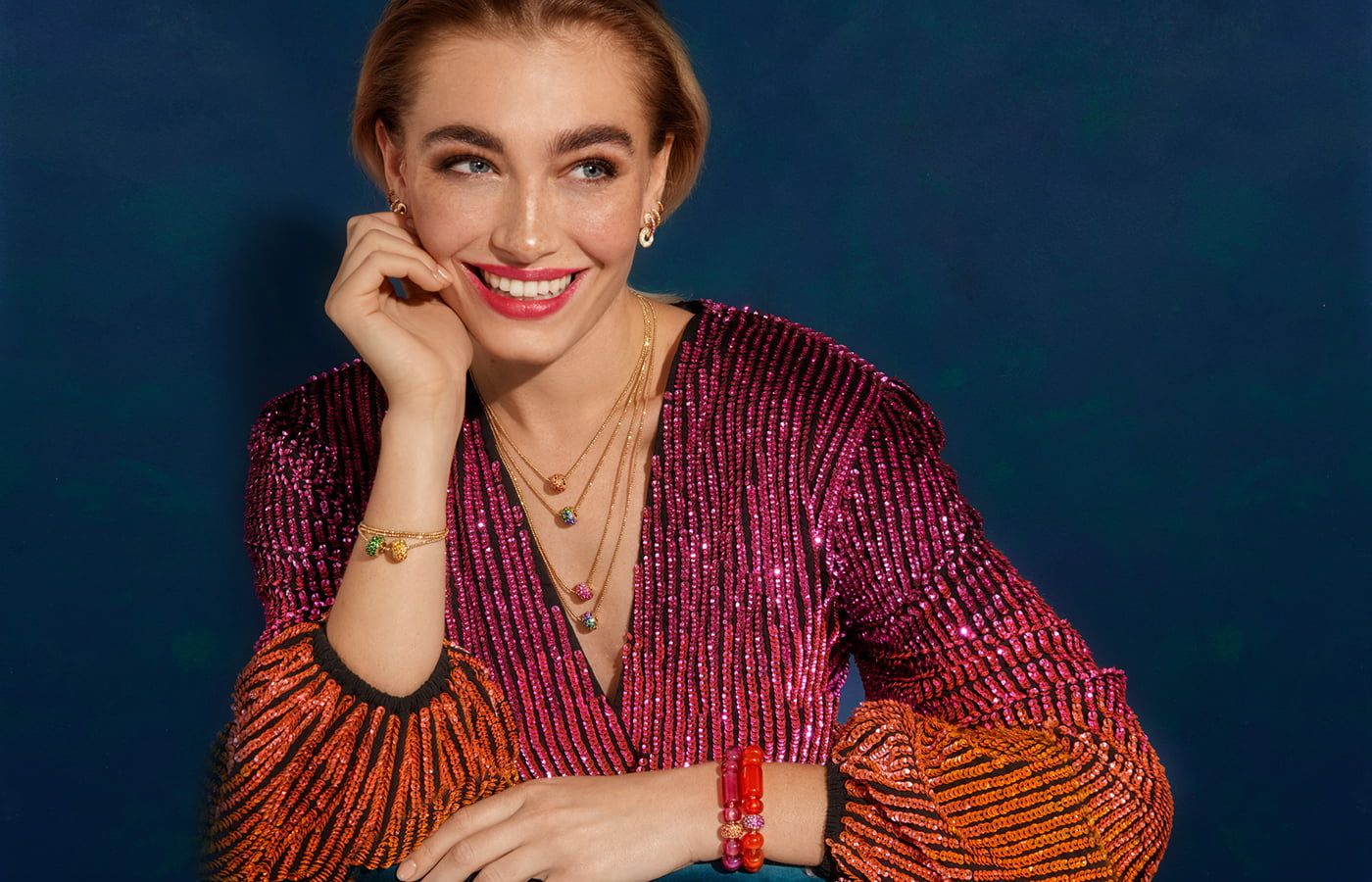 A model wears colourful fine jewellery by Robinson Pelham