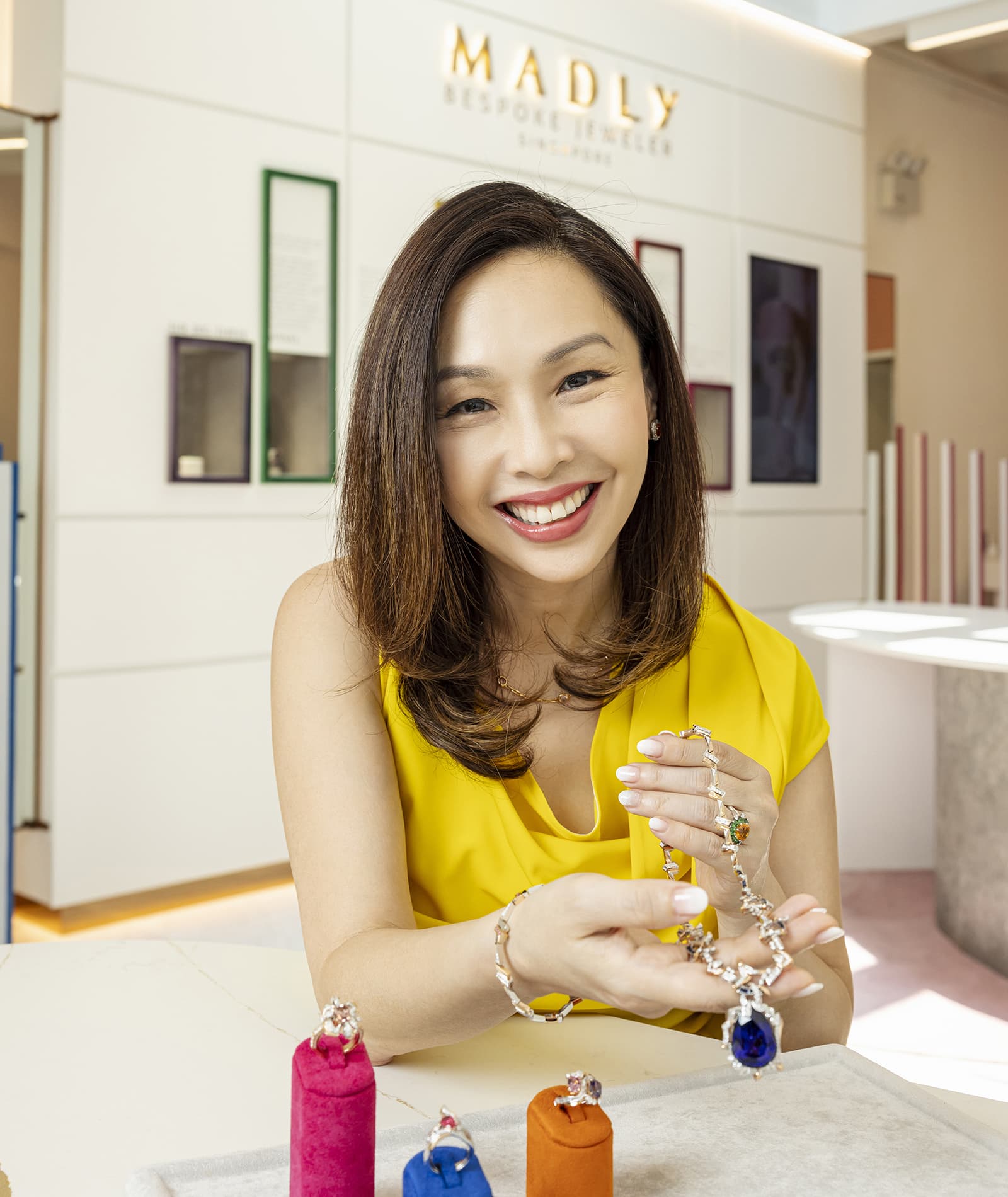 MADLY founder, Maddy barber, holding a MADLY tanzanite and diamond High Jewellery necklace 