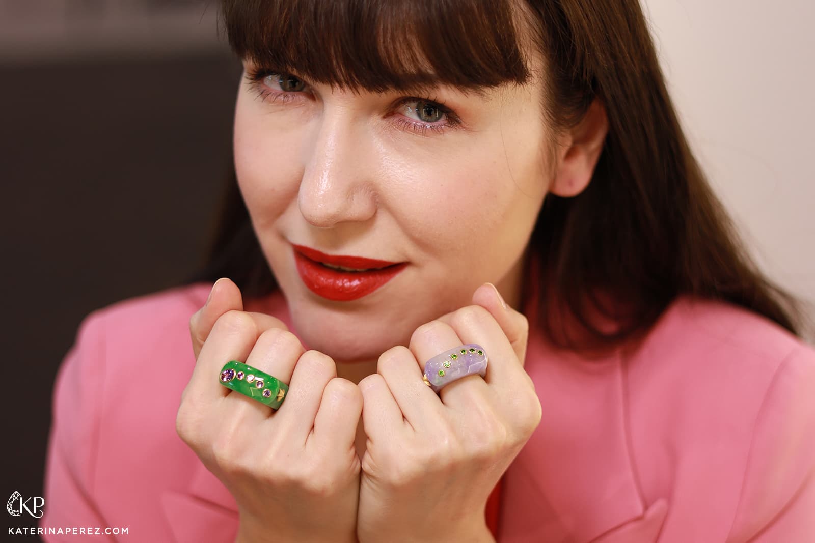 Katerina Perez wears a green jade ring with lavender spinels and a lavender jade ring with demantoid garnets in 18k gold by Sean Gilson 
