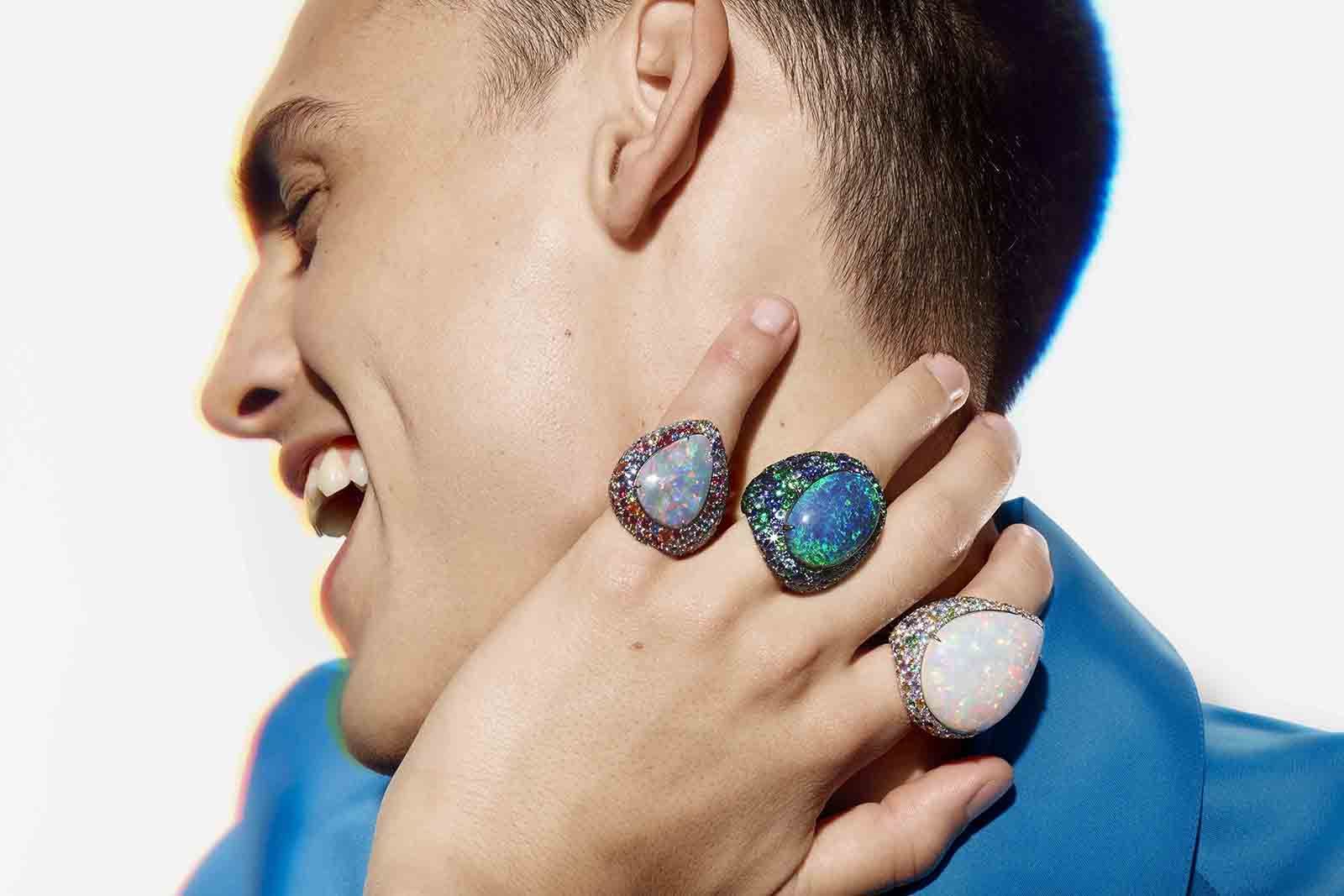 A model wears the complete trio of Illusion opal-set rings from the Boucheron Holographique High Jewellery collection