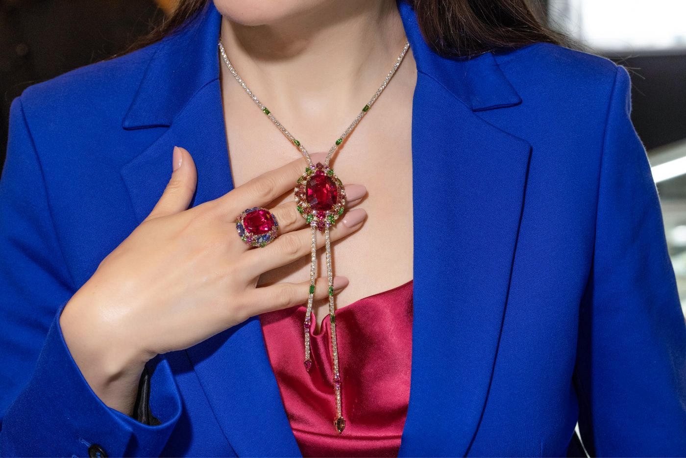 Katerina Perez wearing a Sofragem High Jewellery necklace and cocktail ring featuring a 37-ct rubellite, diamonds, green and pink tourmalines, pink sapphires and tsavorites
