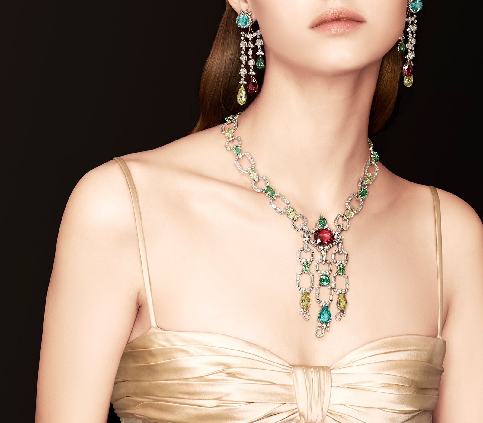 Model wearing Gucci High Jewellery necklace and matching Jacket earrings in white gold, spinel, Paraiba tourmalines, chrysoberyls, spinel and diamonds from the Gucci Allegoria High Jewellery Collection