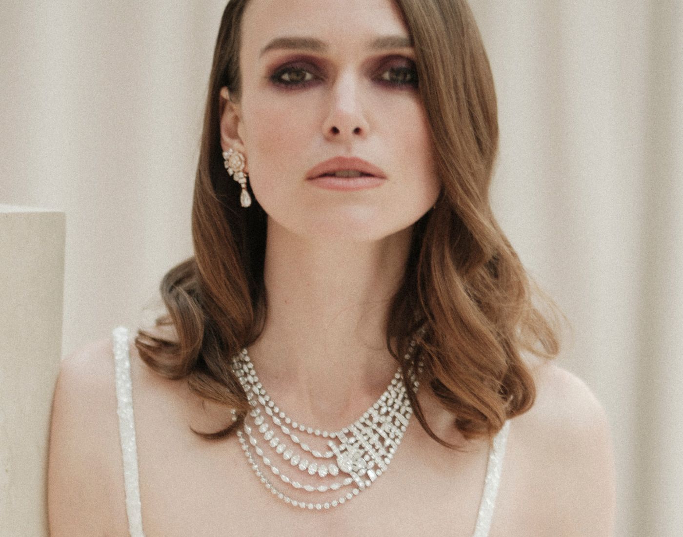 Actress Keira Knightley in the Chanel Tweed Mademoiselle necklace in white gold and diamonds, including an oval-cut diamond of 5.01 carats, from the Tweed Ruban set of the Tweed de Chanel High Jewellery Collection. 