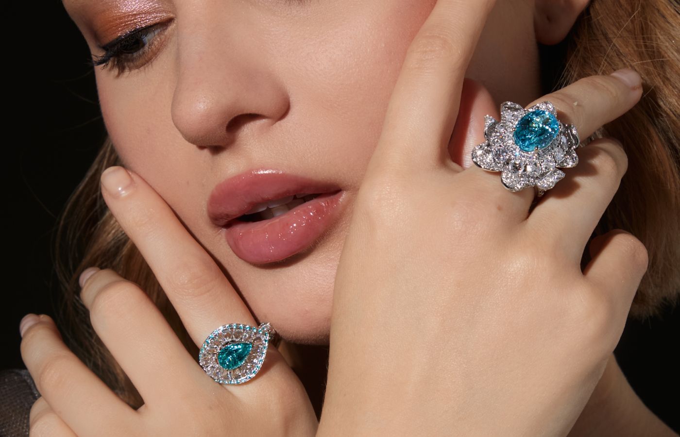 A model wears the Sunita Nahata Ocean Eyes ring with Brazillian Paraiba tourmaline and rose-cut diamonds, and the Nilofar ring with Mozambique Paraiba-type tourmalines with rose-cut diamonds