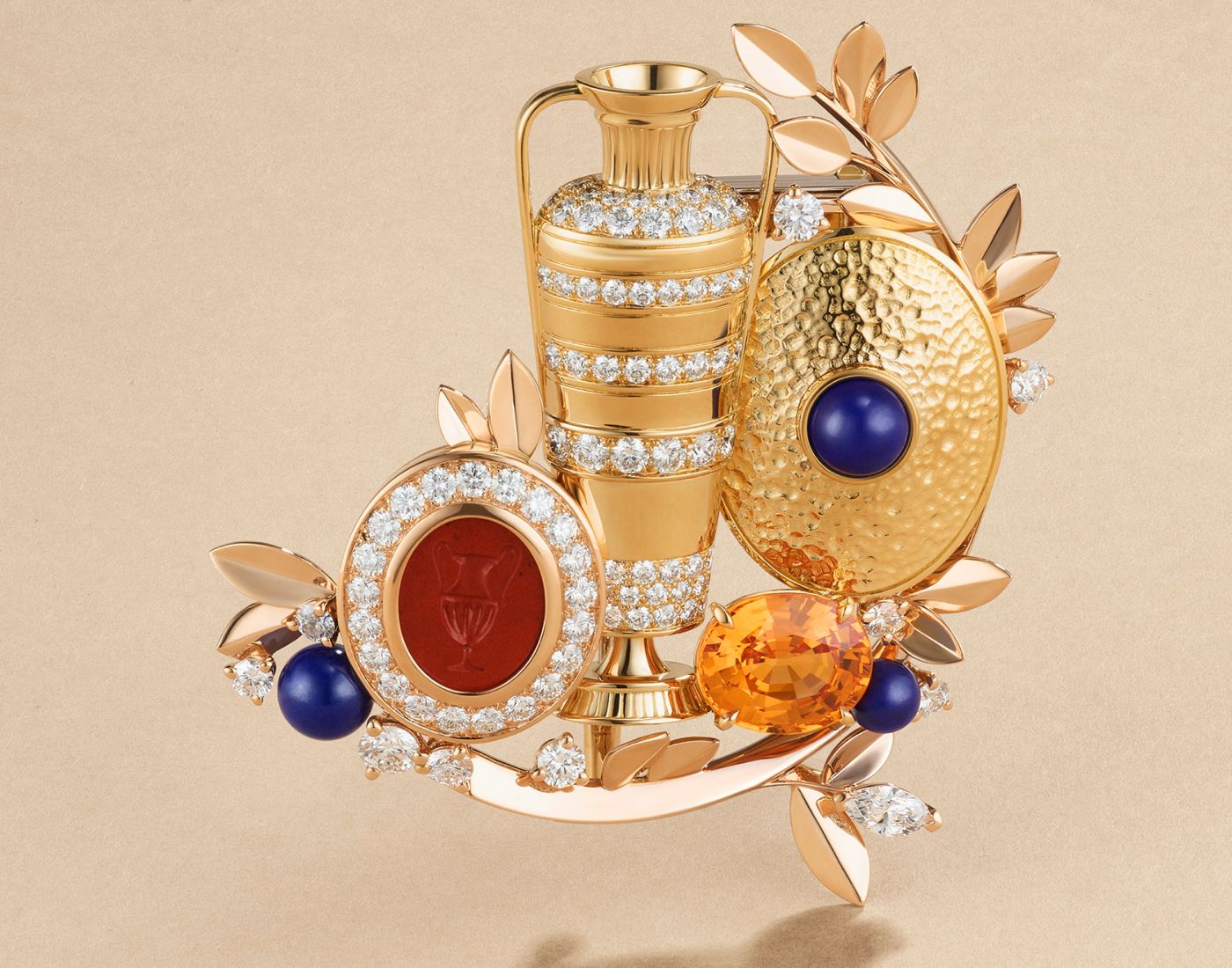 Van Cleef & Arpels Anfora clip in gold, rose gold, a 3.47-ct carved red jasper motif, a 4.87-ct oval-cut spessartite garnet, lapis lazuli and diamonds from Le Grand Tour High Jewellery collection