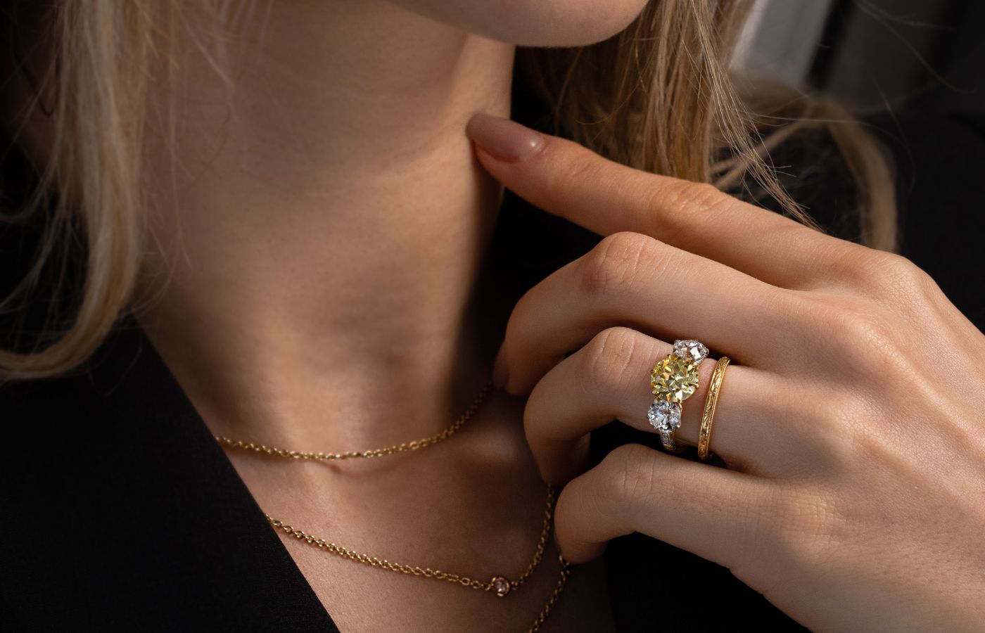 Model wearing a Hancocks antique 2.41-ct Fancy Intense yellow diamond ring with Old European-cut diamond shoulders