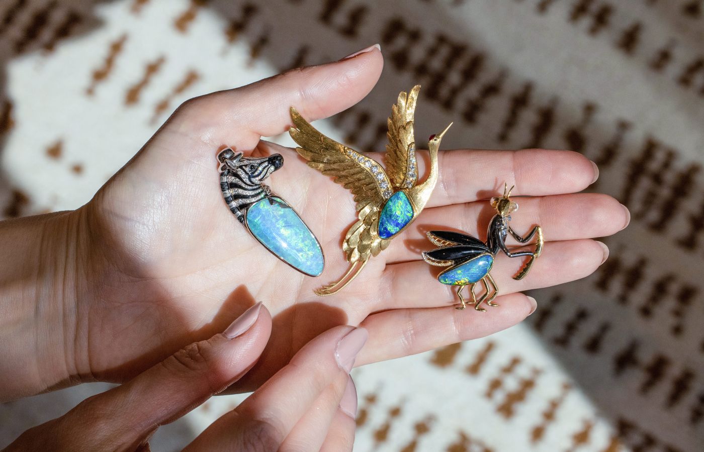 A trio of nature-inspired brooches by Cindy Xu, including a crane in 18k gold with a 3.48 carat black opal and diamonds, and a praying mantis with a 4.4 carat boulder opal, black agate and black diamonds, also in 18k gold 