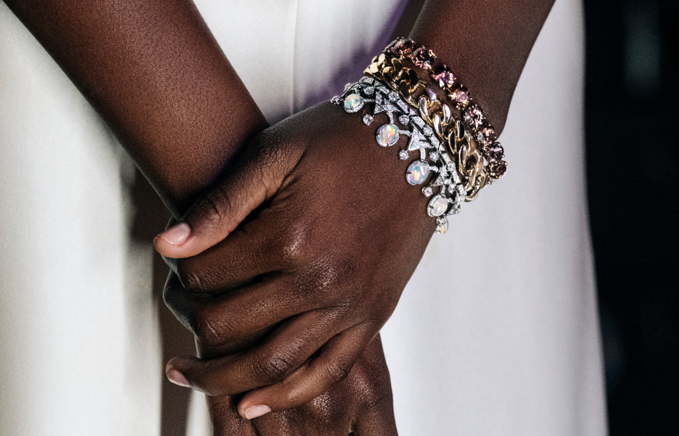 A model wears the Louis Vuitton Rupture bracelet from the Deep Time High Jewellery collection with mixed metals, opals, diamonds and coloured gemstones 