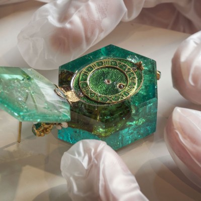 A one-of-a-kind hexagonal emerald watch sits next to the Medusa emerald