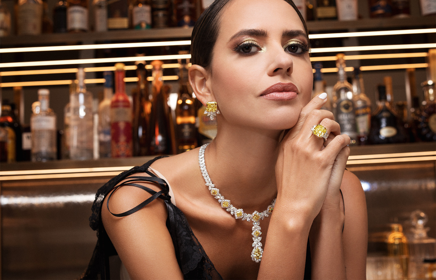 Model wearing Bayco ring in platinum and gold set with a 13-ct fancy yellow diamond and diamonds, a necklace in platinum and gold set with 23-cts of fancy yellow diamonds and 52-cts of diamonds and a pair of ear clips in platinum and gold set with a 31-ct pair of fancy intense yellow diamonds