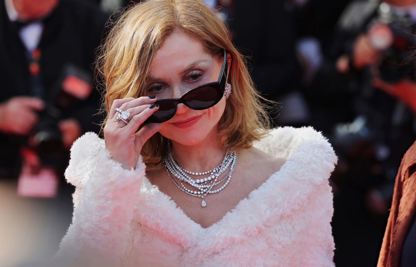 Isabelle Huppert at the Cannes Film Festival 2024 wearing layers of De Beers diamonds, including three DB Classic Eternity Line necklaces with a total weight of 79.78 carats