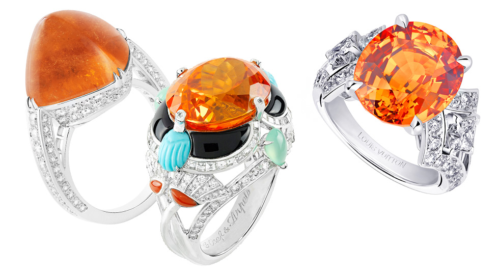 From left to right: Boucheron Joy ring with sugar loaf mandarin garnet and diamonds; Van Cleef&Arpels ring with diamonds, turquoise, coral, chrysoprase, onyx and 1 oval-cut Mandarin garnet of 15.77 carats; Louis Vuitton Acte V Genesis ring with an oval mandarin garnet and diamonds