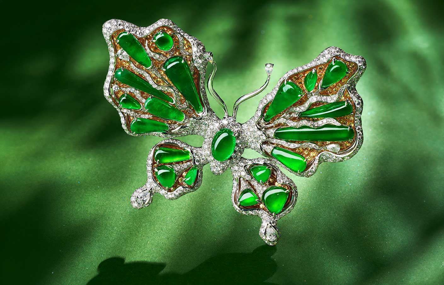 HEHE High Jewelry Butterfly Dreams brooch with 19 green jadeites of various shapes and sizes, set alongside white and yellow diamonds  