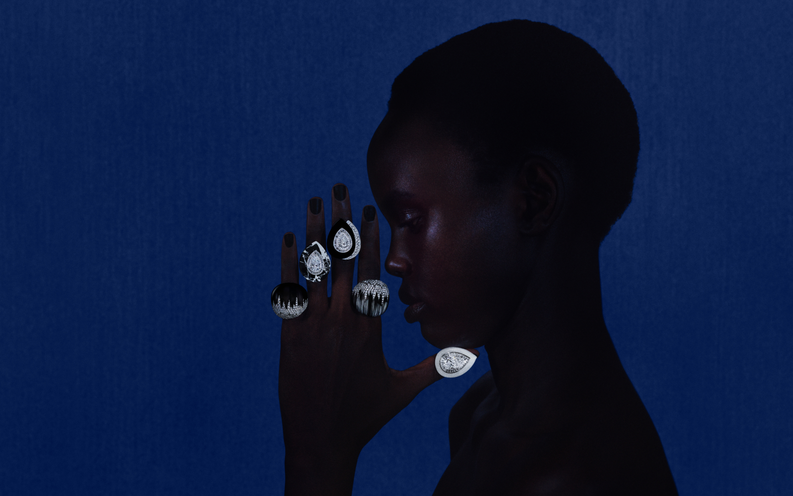 Boucheron Écume rings from the Or Bleu High Jewellery collection, including one in white jade with a 5.08 carat pear-shaped diamond, another carved from a single piece of black obsidian with diamonds and titanium, and three rock crystal and diamond creations 