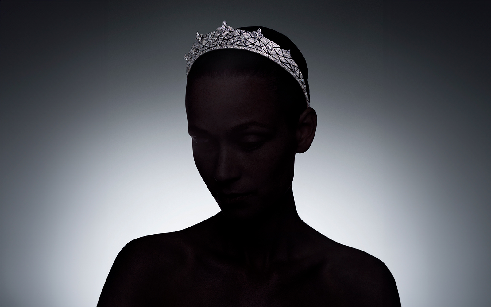 Model wearing the Louis Vuitton Elegance tiara with one 1.53 - carat LV Monogram Star cut diamond, 2.85 - carats of LV Monogram Star cut diamonds and diamonds in white gold from the Awakened Hands, Awakened Minds collection