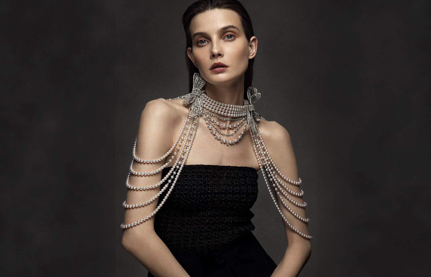 A model wears a Mikimoto body jewel with Akoya cultured pearls and diamonds set in 18k white gold from ‘The Bows’ High Jewellery collection 