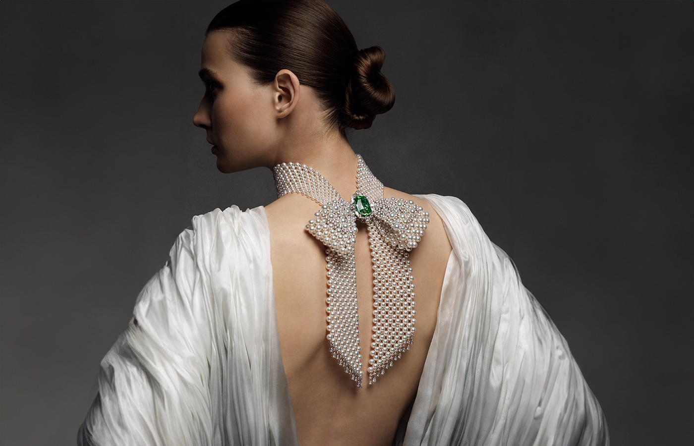 A model wears a Mikimoto necklace with Akoya cultured pearls, round brilliant-cut diamonds, fancy-cut diamonds and a 53.17-carat sea-green tourmaline from ‘The Bows’ High Jewellery collection