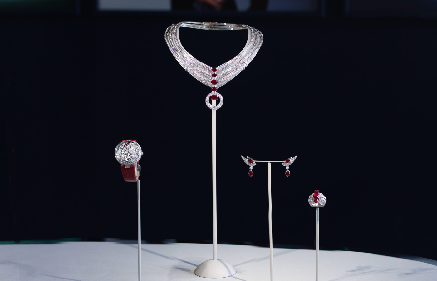 Chaumet Swing watch from the En Scène collection with diamonds and rubies on a red alligator strap, Chaumet Illusion necklace, earrings and ring from the En Scène collection with diamonds and rubies in 18k white gold