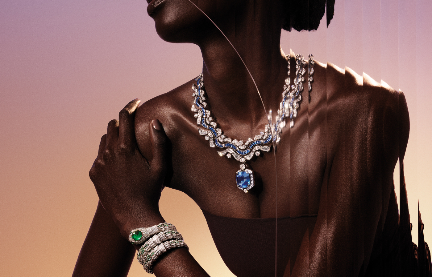 Model wears Bvlgari Aeterna Waves necklace from the Aeterna collection with a 38.93ct sapphire centrepiece and brilliant-cut, buff-top, baguette and pave-set diamonds and sapphires in 18k white gold, on her wrist she wears a Serpenti high jewellery watch with a 12.41-carat emerald and diamonds in 18k white gold