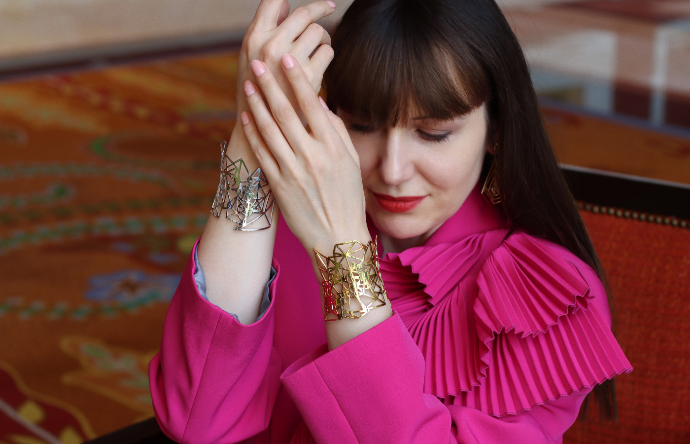 Katerina Perez wears cuff bracelets from the Robert Guild Shattered collection in 18k white and 18k yellow gold 