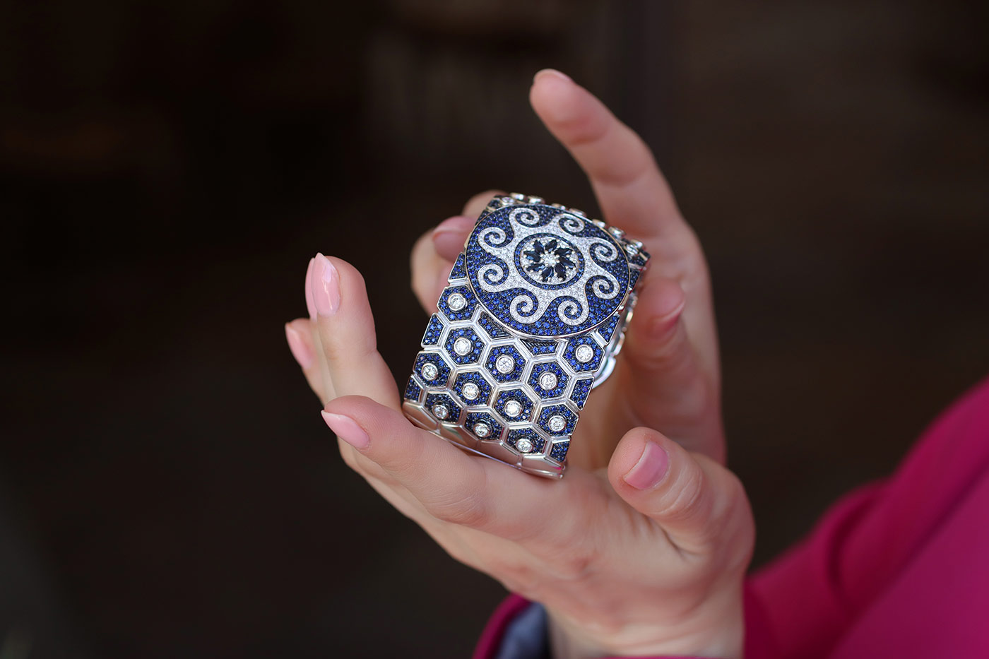 Katerina Perez holds the Miseno Baia Sommersa cuff bracelet with 4.51 carats of white diamonds and 12.73 carats of blue sapphires, inspired by a new underwater mosaic found at the Parco Sommerso di Baia