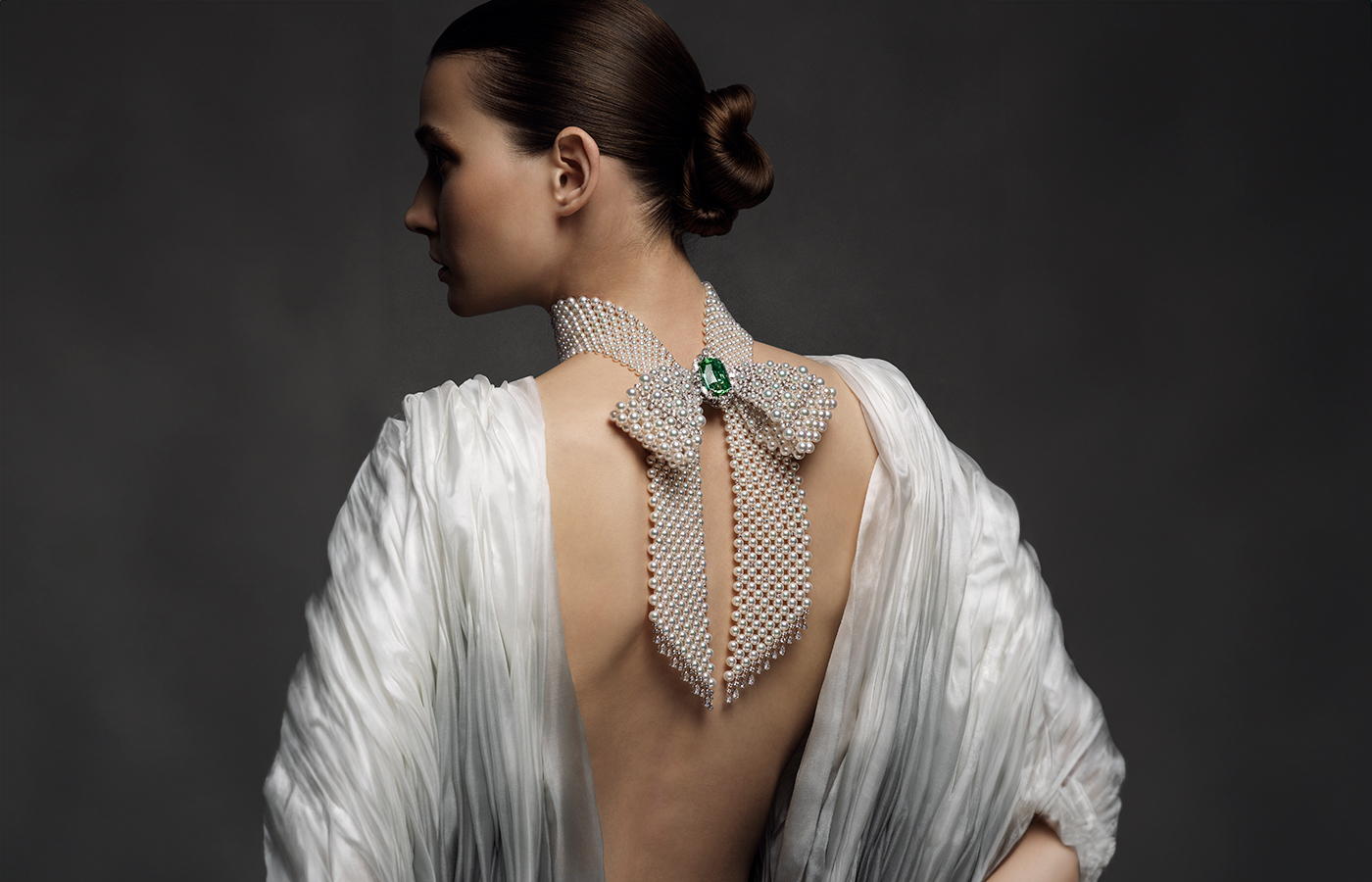 Model wears Mikimoto high jewellery necklace with Akoya cultured pearls, tourmaline and diamonds in 18k white gold, from The Bows collection