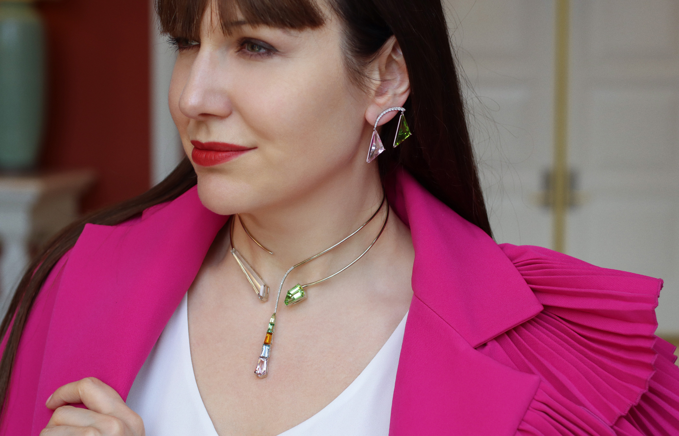 Katerina Perez wears the Robert Guild Confluence necklace with fancy-cut gemstones including an 18.97 carat ‘platinum beryl’ (goshenite), a 10.75-carat peridot, a 1.89-carat clinohumite, a 4.77-carat morganite, a 2.22-carat aquamarine, a 1.48-carat grossular garnet and a 0.97-carat chrysoberyl, plus diamonds in 18k white gold, and the Confluence earrings with 8.75 carats of peridot, 6.78 carats of morganite and round brilliant-cut diamonds 