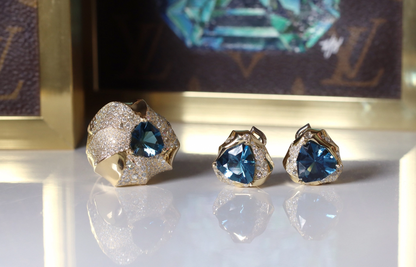 Hugo Cahill Phokialí ring (left) with topaz and snow-set brilliant- and rose-cut diamonds in 18k yellow gold alongside the matching Phokialí earrings with topaz and diamonds in 18k palladium white gold and 18k gold, both from the Renaissance High Jewellery collection