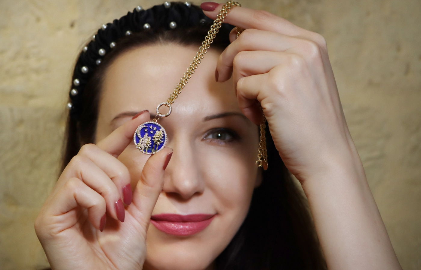 Katerina Perez holds the Lionheart Skoven Lapis Lazuli Medallion with diamonds in 14k yellow gold 