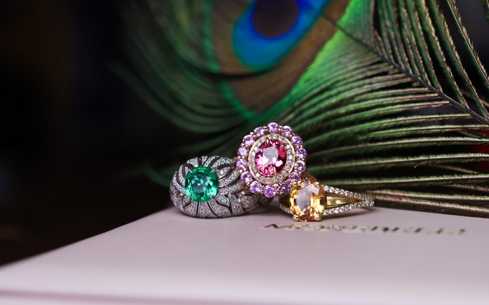 A trio of rings with Malagasy coloured gemstones by Morebelli including (from left to right) a 1.68 carat emerald ring set with 196 diamonds, a ring set with a 1.35 carat pink tourmaline and 1.10 carats of pink sapphires, and a 3.03 carat golden sapphire ring with diamonds